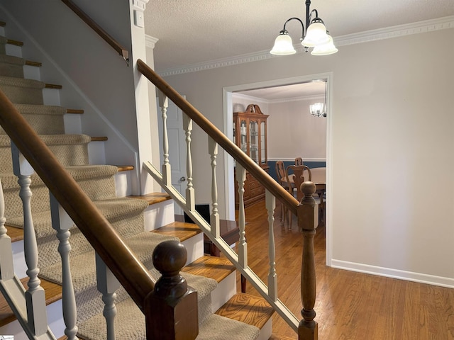 111 Firethorne Ct, Greer, SC 29650 - staircase with a chandelier, wood finished floors, crown molding, and baseboards