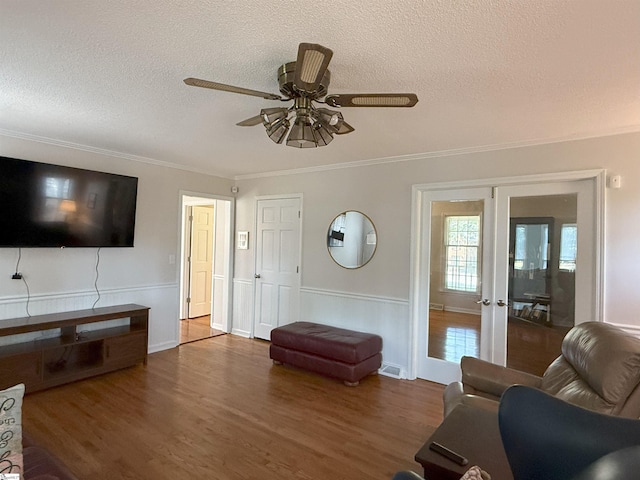 111 Firethorne Ct, Greer, SC 29650 - living room with a ceiling fan, a textured ceiling, wood finished floors, ornamental molding, and french doors