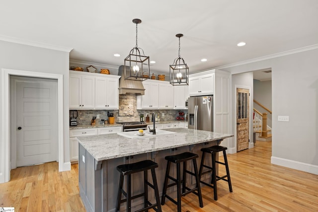 105 Tall Oaks Ct, Easley, SC 29642 - kitchen with appliances with stainless steel finishes, premium range hood, ornamental molding, decorative backsplash, and white cabinetry