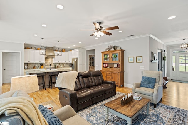 105 Tall Oaks Ct, Easley, SC 29642 - living area with recessed lighting, a ceiling fan, light wood-style floors, crown molding, and a chandelier