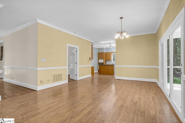 107 Cinder Creek Ln, Spartanburg, SC 29307 - unfurnished living room with a chandelier, light wood-type flooring, baseboards, and ornamental molding
