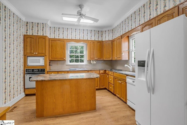 107 Cinder Creek Ln, Spartanburg, SC 29307 - kitchen with white appliances, wallpapered walls, crown molding, a sink, and a center island