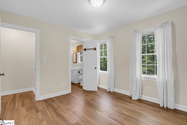 107 Cinder Creek Ln, Spartanburg, SC 29307 - unfurnished bedroom featuring wood finished floors, baseboards, and ensuite bath