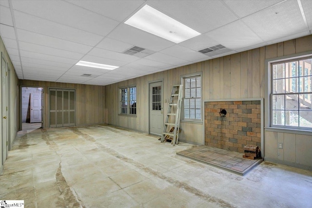 107 Cinder Creek Ln, Spartanburg, SC 29307 - spare room with wooden walls, healthy amount of natural light, a drop ceiling, and concrete flooring