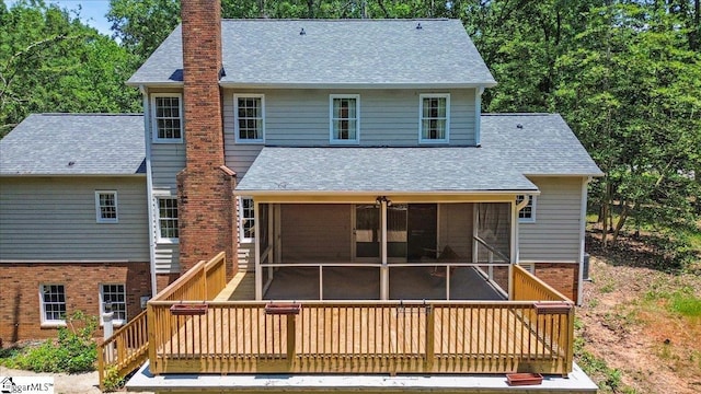 107 Cinder Creek Ln, Spartanburg, SC 29307 - back of property featuring a sunroom, a chimney, a shingled roof, and a wooden deck