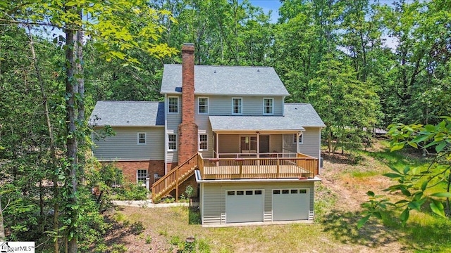 107 Cinder Creek Ln, Spartanburg, SC 29307 - rear view of property featuring a sunroom, a chimney, stairway, and an attached garage