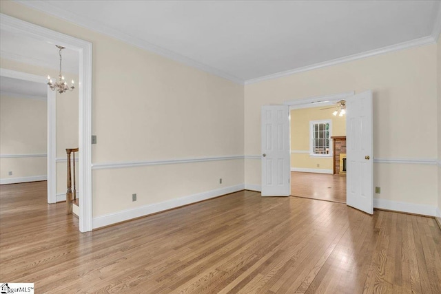 107 Cinder Creek Ln, Spartanburg, SC 29307 - spare room with wood finished floors, crown molding, a chandelier, baseboards, and ceiling fan