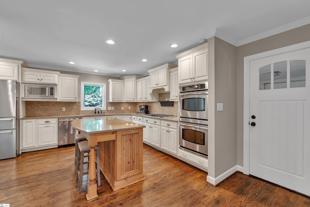103 Brandon Way, Simpsonville, SC 29681 - kitchen with stainless steel appliances, a sink, crown molding, tasteful backsplash, and light stone countertops