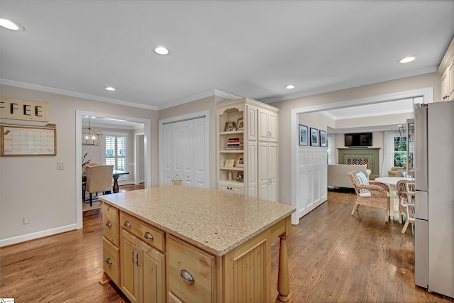 103 Brandon Way, Simpsonville, SC 29681 - kitchen with freestanding refrigerator, crown molding, light wood finished floors, a fireplace, and light stone countertops