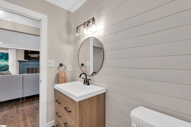 103 Brandon Way, Simpsonville, SC 29681 - half bathroom with vanity, toilet, wood finished floors, wood walls, and a brick fireplace