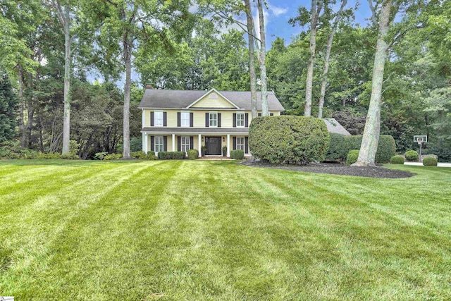 103 Brandon Way, Simpsonville, SC 29681 - colonial-style house featuring a front lawn, covered porch, and view of scattered trees