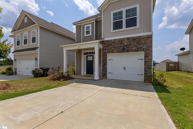 249 Samuel St, Pendleton, SC 29670 - view of front of property with stone siding, an attached garage, concrete driveway, and a front lawn