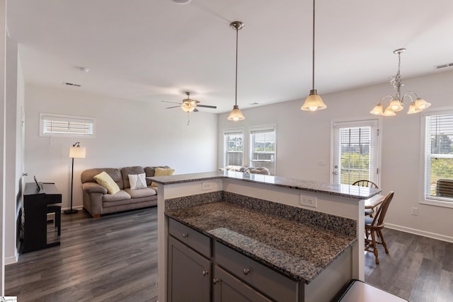 249 Samuel St, Pendleton, SC 29670 - kitchen with dark wood-type flooring, dark stone countertops, open floor plan, a chandelier, and hanging light fixtures