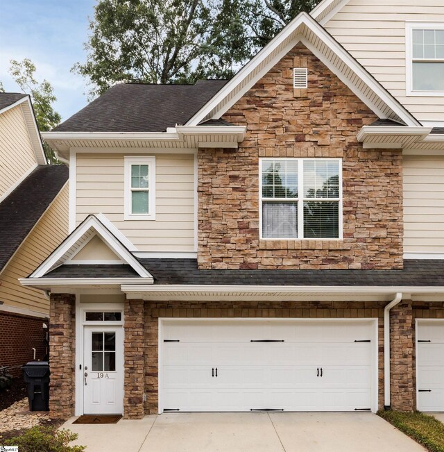 19 Edge Ct Unit A, Greenville, SC 29609 - view of property with stone siding, a garage, roof with shingles, and driveway