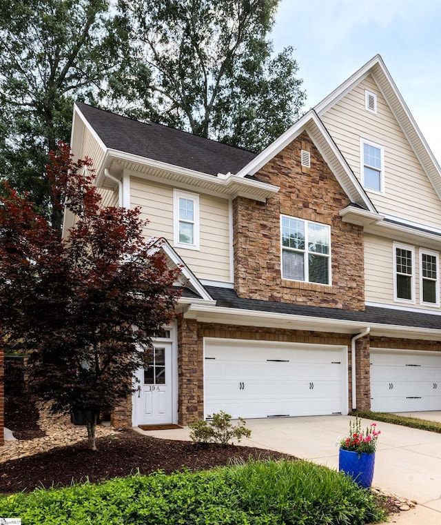 19 Edge Ct Unit A, Greenville, SC 29609 - view of front of house featuring a garage, stone siding, driveway, and roof with shingles