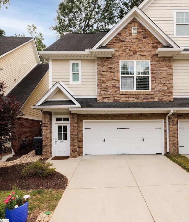 19 Edge Ct Unit A, Greenville, SC 29609 - view of front of home with stone siding, a garage, concrete driveway, and a shingled roof