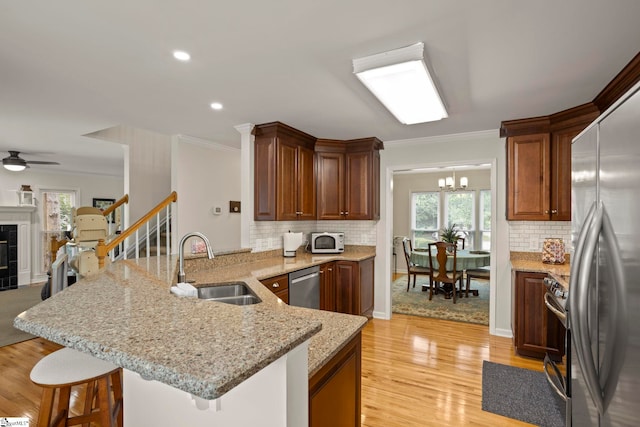 4 Jester Ct, Simpsonville, SC 29681 - kitchen featuring a sink, stainless steel appliances, a peninsula, a kitchen bar, and ornamental molding