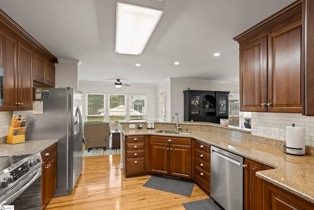 4 Jester Ct, Simpsonville, SC 29681 - kitchen with stainless steel appliances, a sink, crown molding, light wood finished floors, and light stone countertops