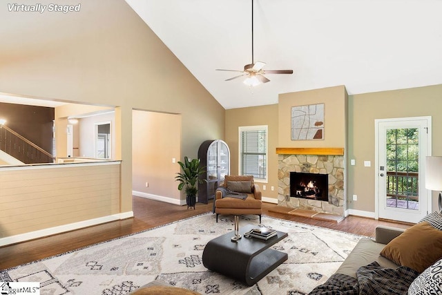 30 Caperton Way, Greer, SC 29651 - living area with high vaulted ceiling, wood finished floors, baseboards, a ceiling fan, and a stone fireplace