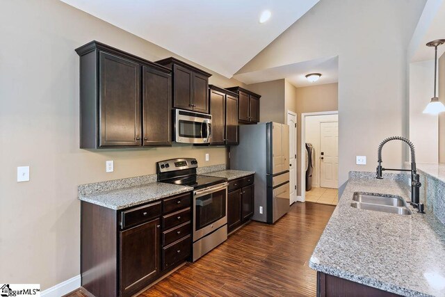 30 Caperton Way, Greer, SC 29651 - kitchen featuring stainless steel appliances, a sink, vaulted ceiling, dark brown cabinets, and dark wood-type flooring