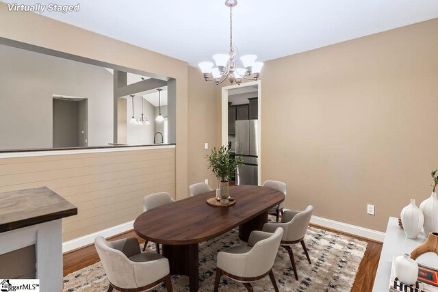 30 Caperton Way, Greer, SC 29651 - dining space featuring a chandelier, wood finished floors, and baseboards