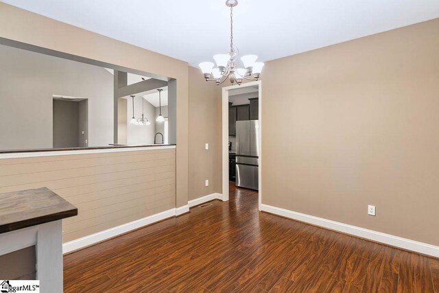 30 Caperton Way, Greer, SC 29651 - unfurnished dining area with a chandelier, baseboards, and wood finished floors