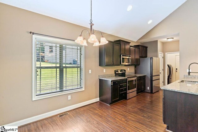 30 Caperton Way, Greer, SC 29651 - kitchen with stainless steel appliances, a sink, a chandelier, vaulted ceiling, and dark wood-type flooring