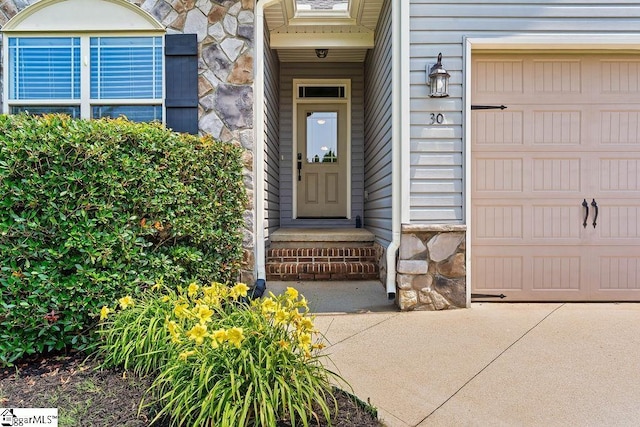 30 Caperton Way, Greer, SC 29651 - view of exterior entry with stone siding and an attached garage