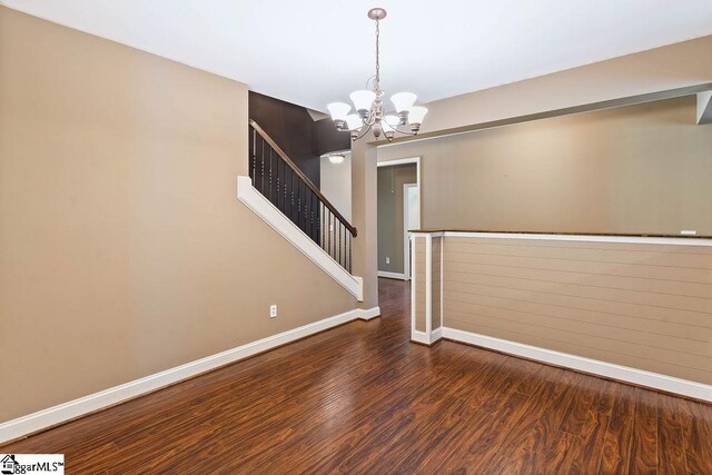 30 Caperton Way, Greer, SC 29651 - unfurnished room featuring baseboards, a chandelier, wood finished floors, and stairway