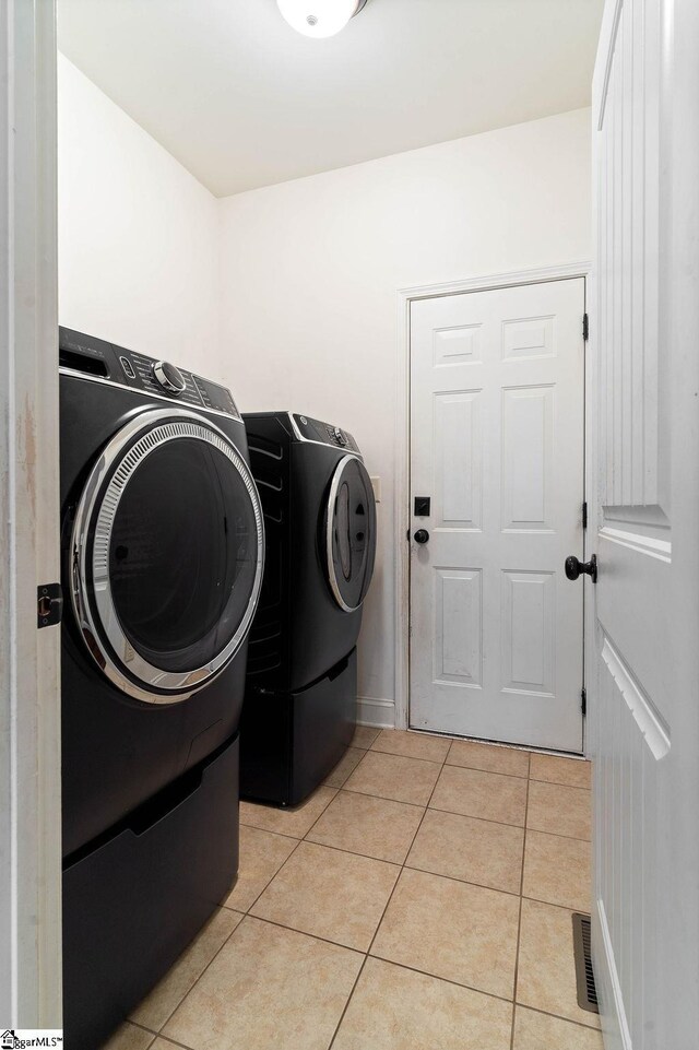 30 Caperton Way, Greer, SC 29651 - laundry area with washing machine and clothes dryer, light tile patterned flooring, and baseboards