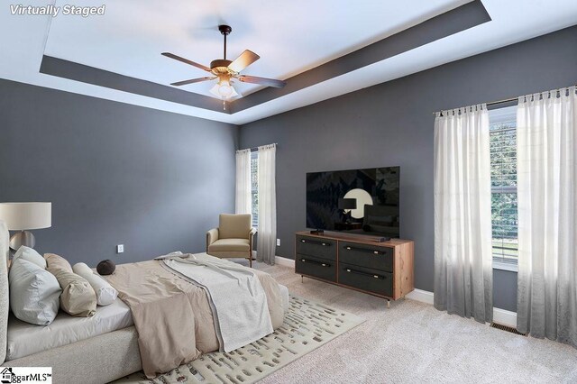 30 Caperton Way, Greer, SC 29651 - bedroom featuring a raised ceiling, baseboards, light colored carpet, and a ceiling fan