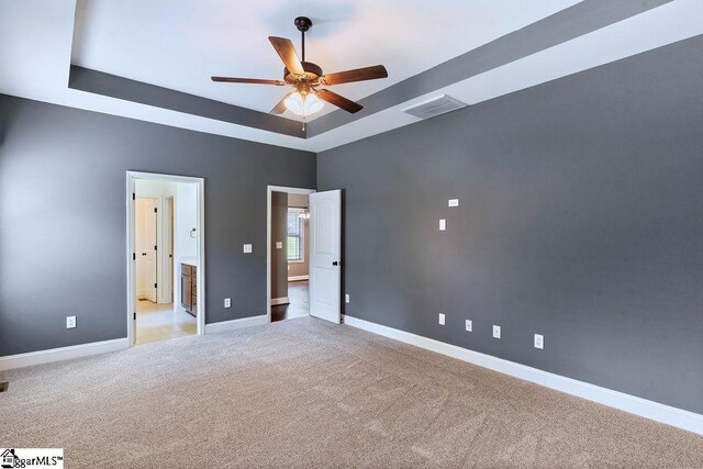 30 Caperton Way, Greer, SC 29651 - unfurnished bedroom featuring a tray ceiling, light carpet, baseboards, and ceiling fan