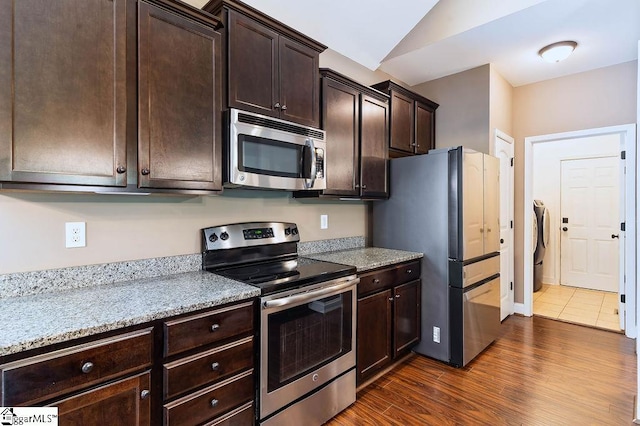 30 Caperton Way, Greer, SC 29651 - kitchen with stainless steel appliances, dark brown cabinetry, dark wood-style flooring, lofted ceiling, and washer and dryer