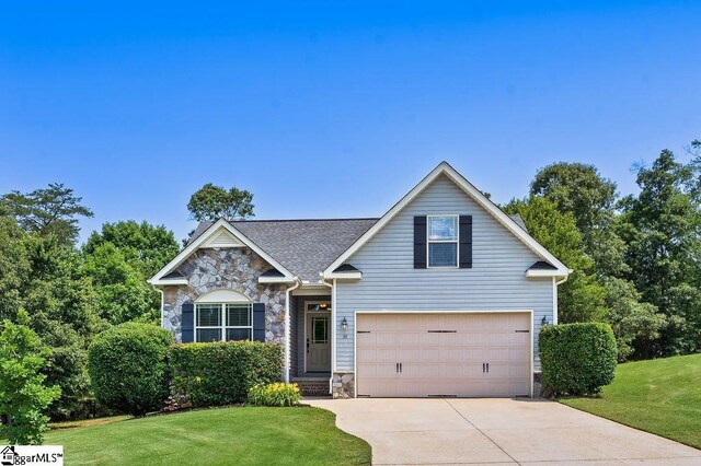 30 Caperton Way, Greer, SC 29651 - traditional-style house with stone siding, a front yard, concrete driveway, and a garage