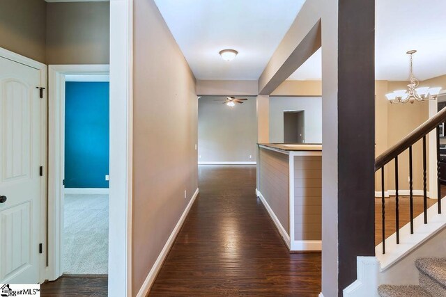 30 Caperton Way, Greer, SC 29651 - hallway featuring dark wood-style flooring, a chandelier, baseboards, and stairway