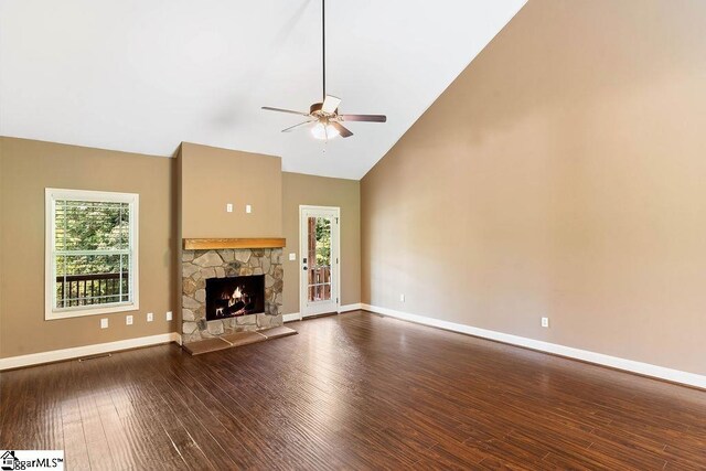 30 Caperton Way, Greer, SC 29651 - unfurnished living room featuring ceiling fan, healthy amount of natural light, high vaulted ceiling, dark wood-type flooring, and a stone fireplace