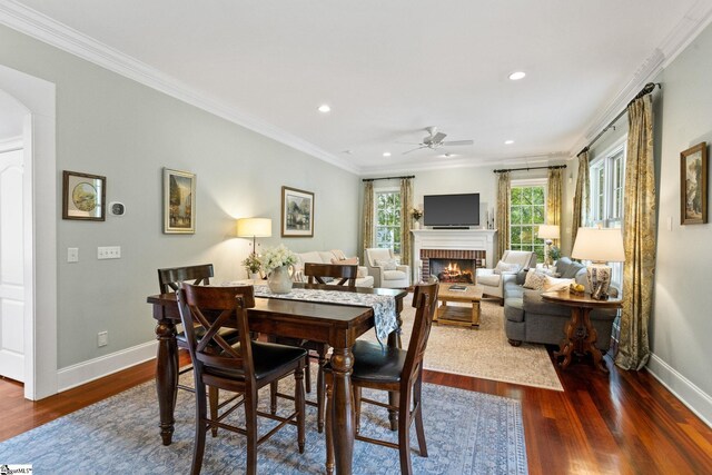 5 Fife Ct, Simpsonville, SC 29681 - dining room with ceiling fan, baseboards, dark wood-type flooring, a brick fireplace, and ornamental molding