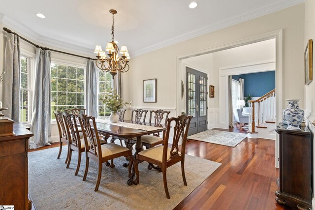 5 Fife Ct, Simpsonville, SC 29681 - dining space featuring stairs, dark wood-style floors, a chandelier, ornamental molding, and wainscoting