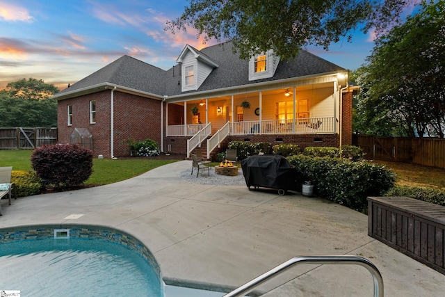 5 Fife Ct, Simpsonville, SC 29681 - back of property at dusk featuring a fire pit, a patio, brick siding, a fenced backyard, and crawl space