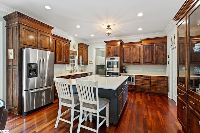 5 Fife Ct, Simpsonville, SC 29681 - kitchen featuring appliances with stainless steel finishes, light countertops, dark wood-type flooring, a center island, and ornamental molding