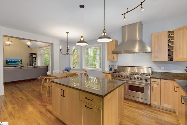 6 Terrapin Trl, Taylors, SC 29687 - kitchen featuring wall chimney range hood, range with two ovens, light brown cabinetry, light wood-style flooring, and open floor plan