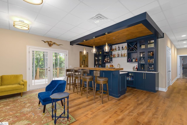 6 Terrapin Trl, Taylors, SC 29687 - indoor wet bar with a paneled ceiling, light wood finished floors, and hanging light fixtures