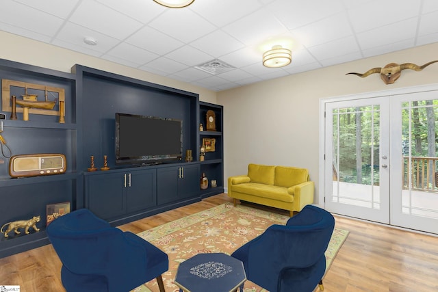 6 Terrapin Trl, Taylors, SC 29687 - living room featuring a paneled ceiling, french doors, and light wood finished floors