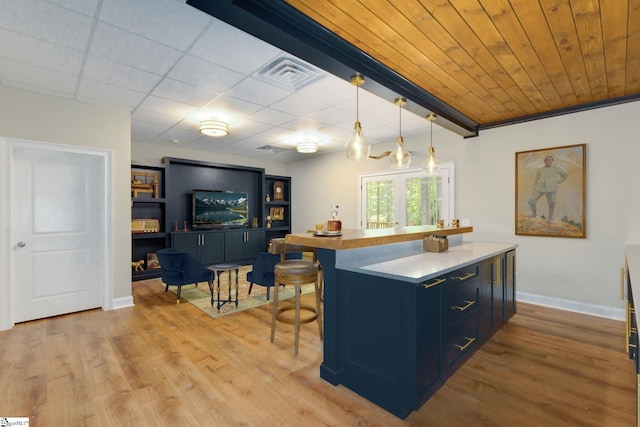 6 Terrapin Trl, Taylors, SC 29687 - kitchen featuring blue cabinetry, a kitchen breakfast bar, light wood-style floors, light countertops, and baseboards