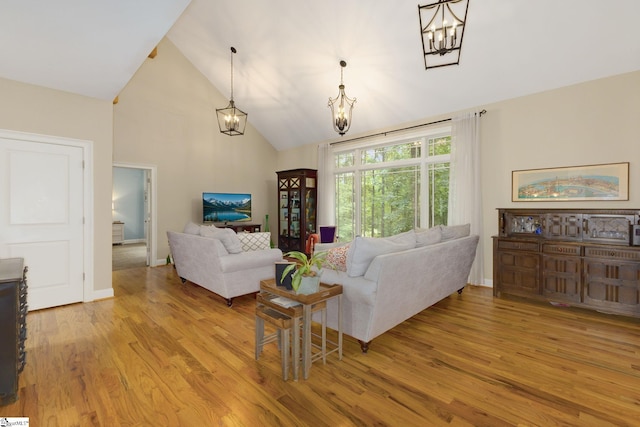 6 Terrapin Trl, Taylors, SC 29687 - living room featuring a chandelier, light wood-type flooring, high vaulted ceiling, and baseboards