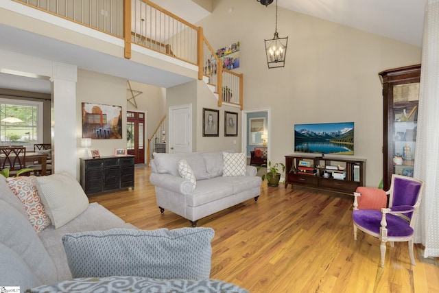 6 Terrapin Trl, Taylors, SC 29687 - living area with high vaulted ceiling, wood finished floors, stairway, and a chandelier