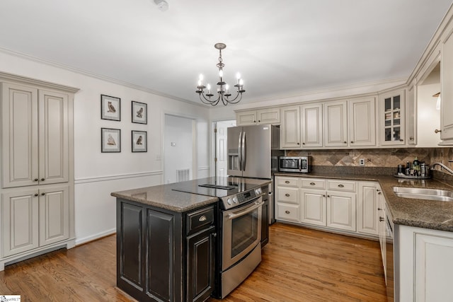119 Circle Slope Dr, Simpsonville, SC 29681 - kitchen featuring a sink, stainless steel appliances, a chandelier, glass insert cabinets, and dark cabinets