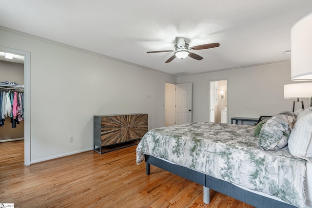 119 Circle Slope Dr, Simpsonville, SC 29681 - bedroom with wood finished floors, crown molding, a walk in closet, a closet, and baseboards