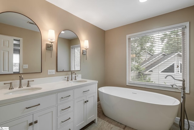 119 Circle Slope Dr, Simpsonville, SC 29681 - bathroom featuring double vanity, a soaking tub, and baseboards