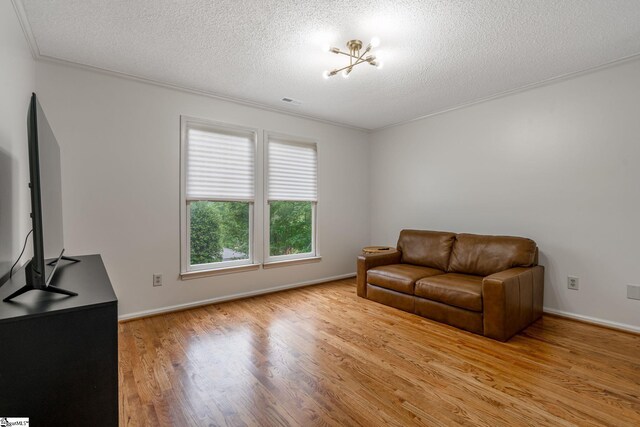 119 Circle Slope Dr, Simpsonville, SC 29681 - living area with a textured ceiling, light wood-style floors, crown molding, and baseboards